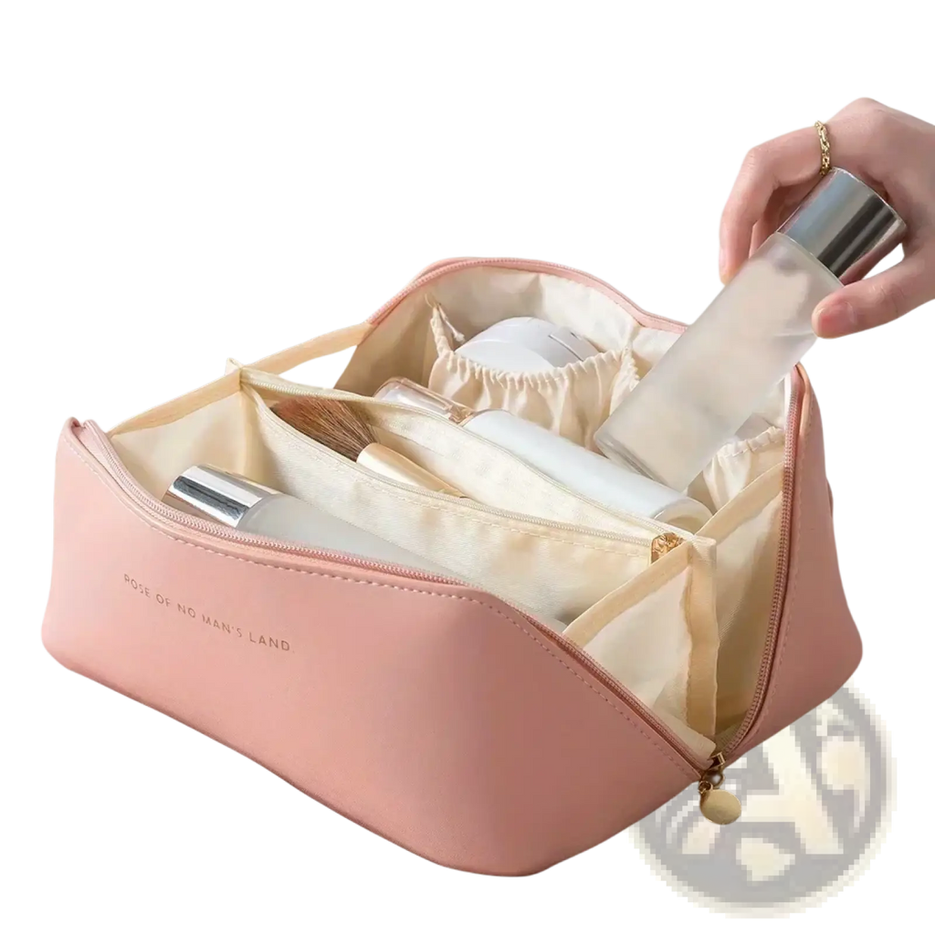 A soft pink faux-leather large travel makeup bag with cream interior and gold-tone zipper pull waterproof organizer