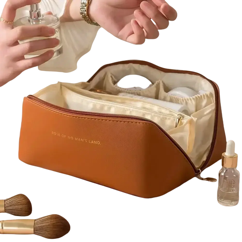 A tan leather large travel makeup bag with cream interior and gold zipper embossed with rose of no mans land
