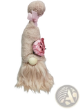 A plush beige lavender and pink gnome doll with a fluffy beard and pink bow as a desktop ornament