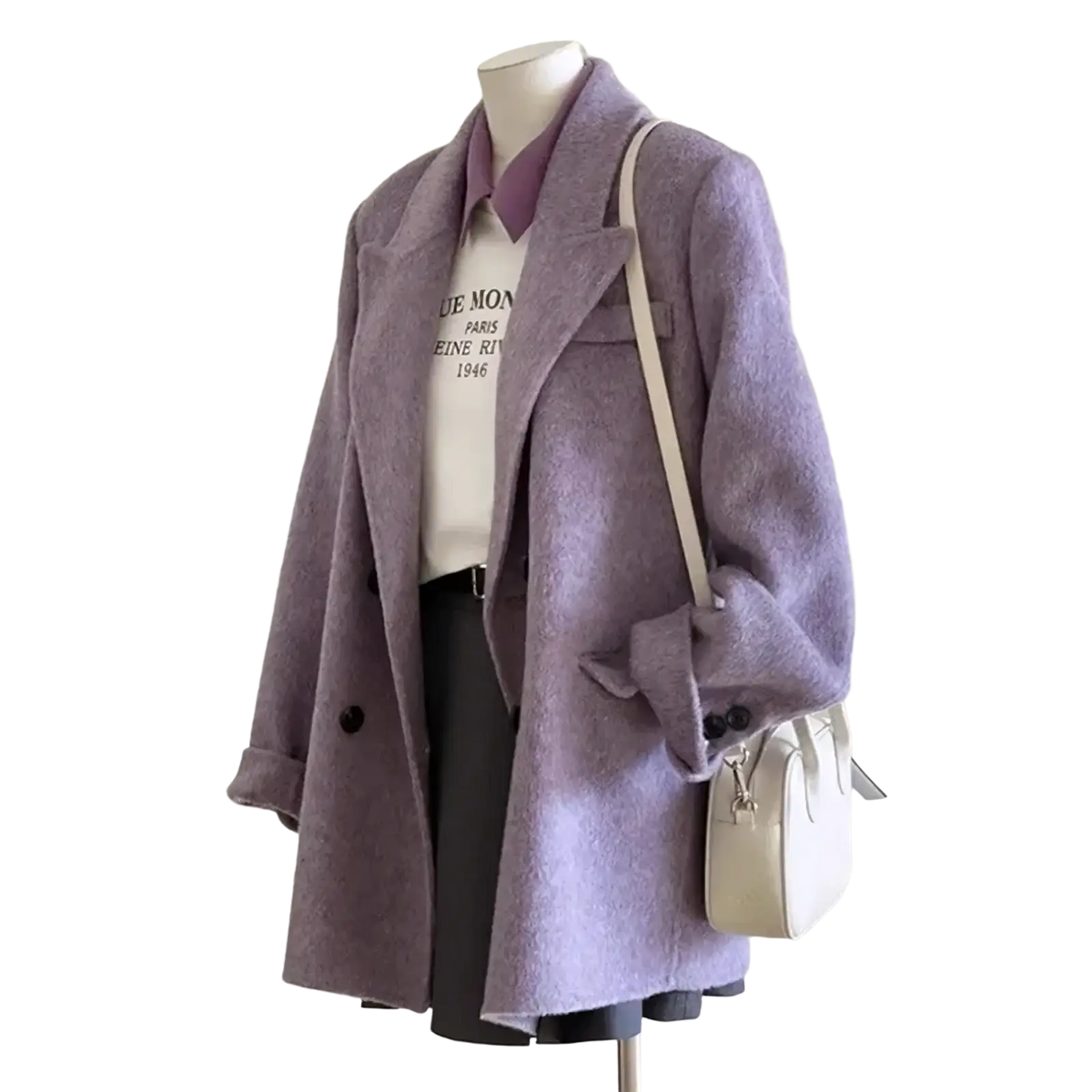 A soft lavender wool double breasted coat with black buttons worn over a white graphic tee and cream crossbody bag
