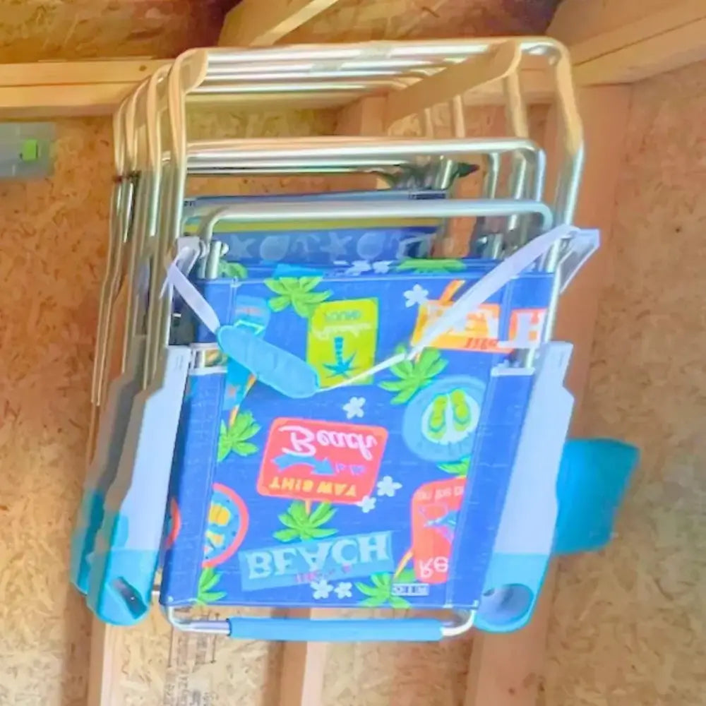 Blue beach-themed folding chair with metallic frame and light blue accents displayed on stud mounted steel lawn chair storage hooks