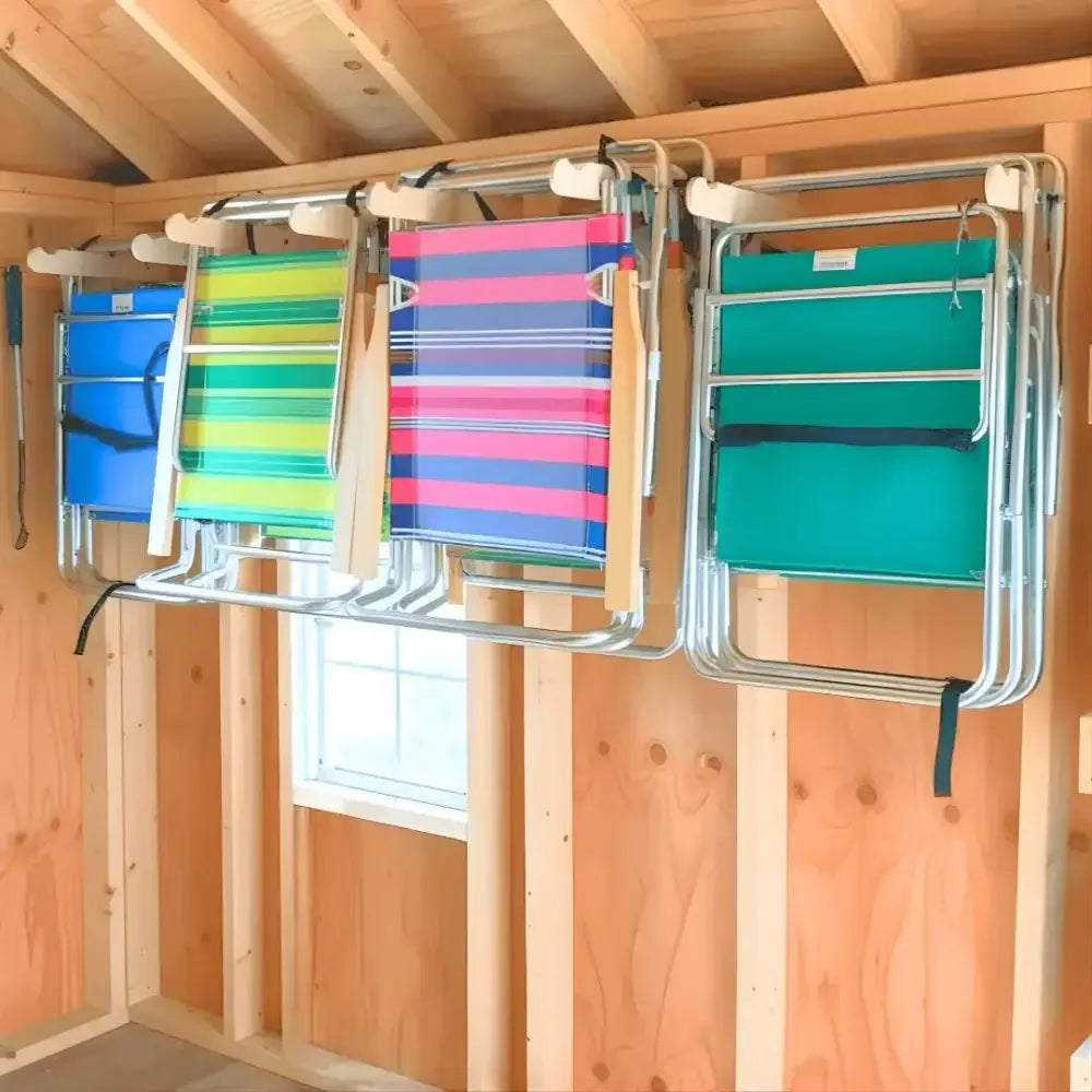 Stud mounted steel lawn chair storage hooks holding four colorful striped metal frame beach chairs on wall rack
