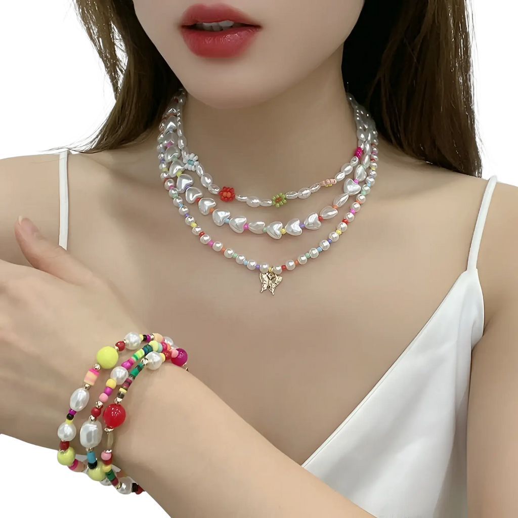 Layered gold butterfly and pearl necklace featuring iridescent pearls and pink and yellow accent beads for women