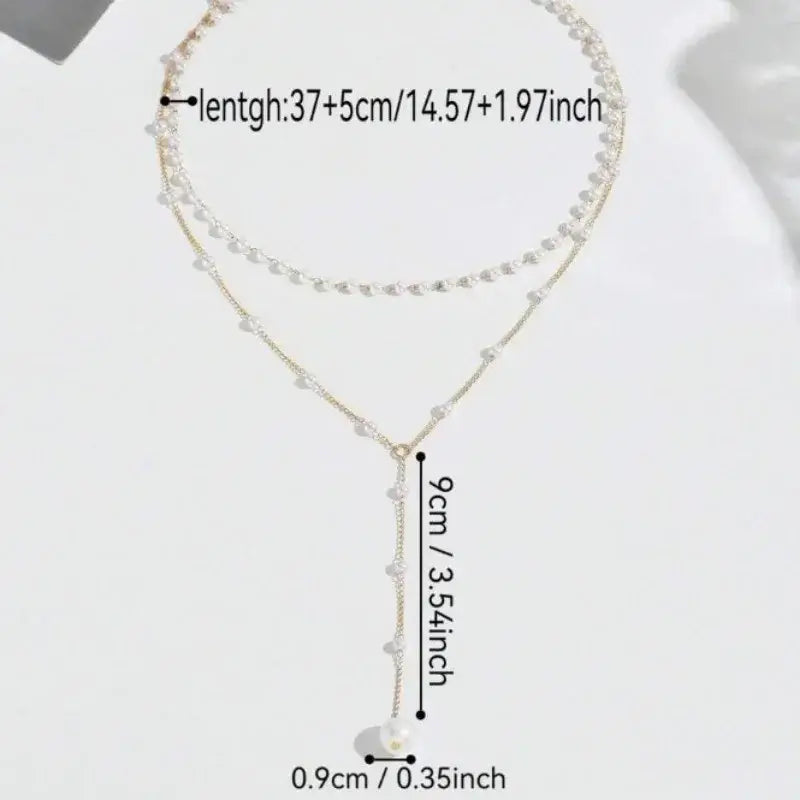 Layered pearl pendant necklace for women with a delicate double-strand gold chain and white y-shaped pearls ending in a larger pearl