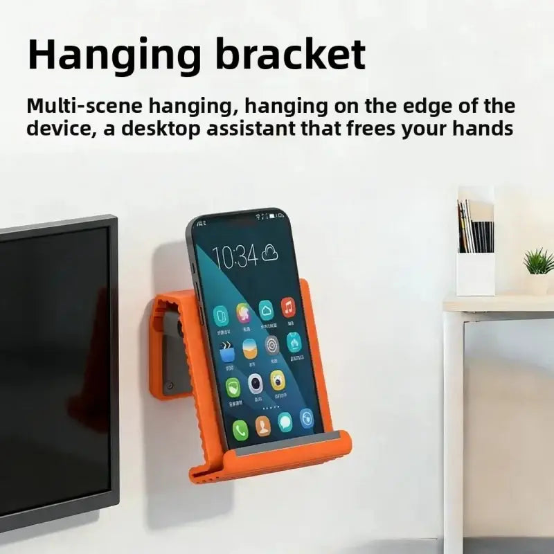 Orange plastic lazy bracket silicone foldable phone stand holding a smartphone for hands-free use