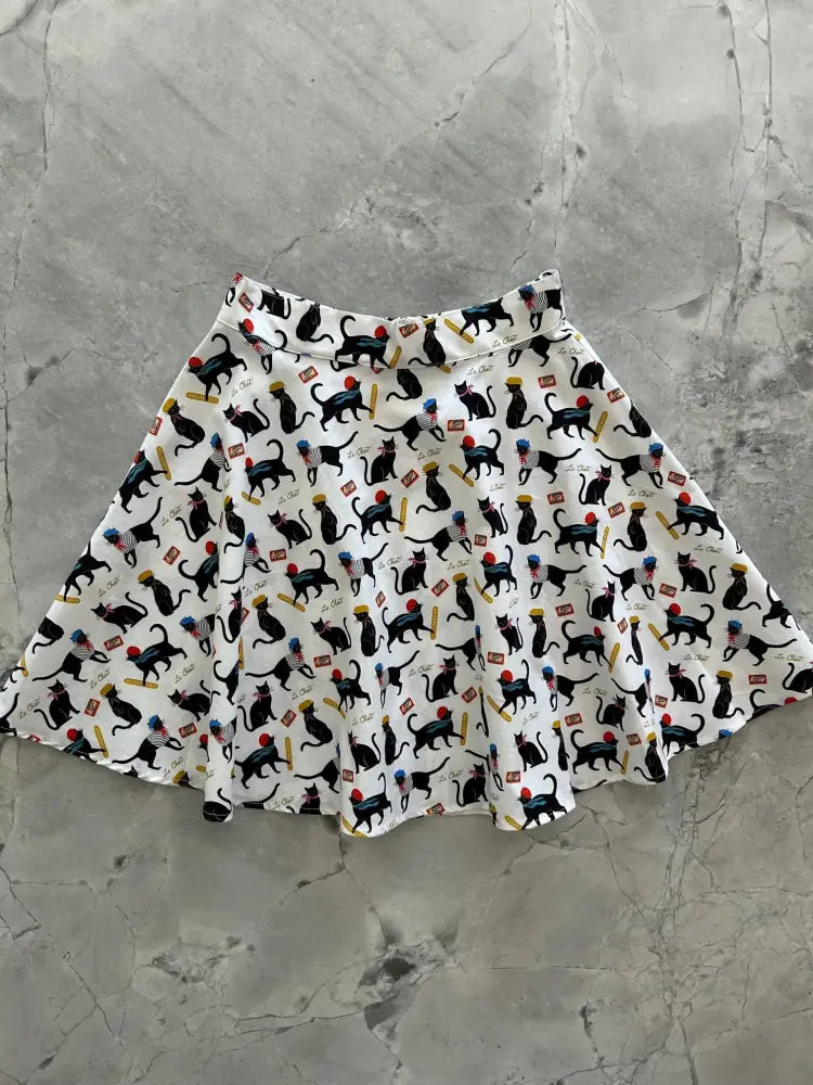 Le Chat Parisian cat print cotton skater skirt in white with black cats holding american flags and colorful balloons
