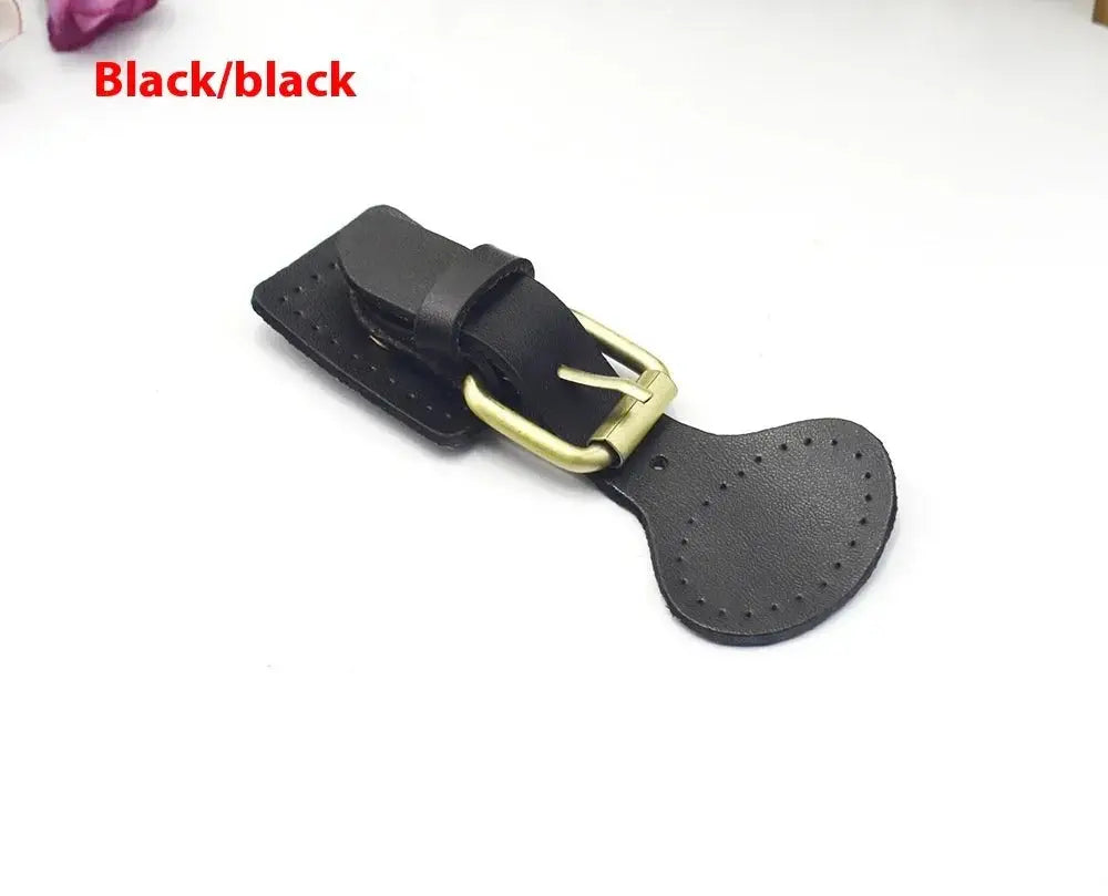 Handcrafted black leather strap with perforated detailing and brass-colored oval hook fastener hardware