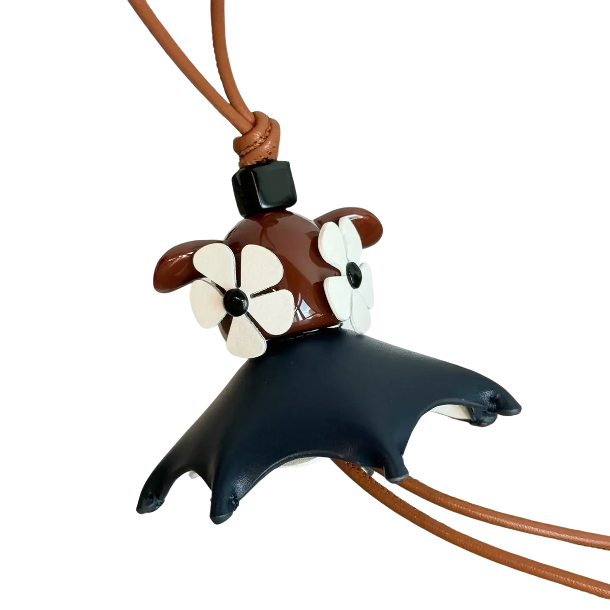 Brown and black leather manta ray keychain with white flower embellishments designed as a cute animal bag charm