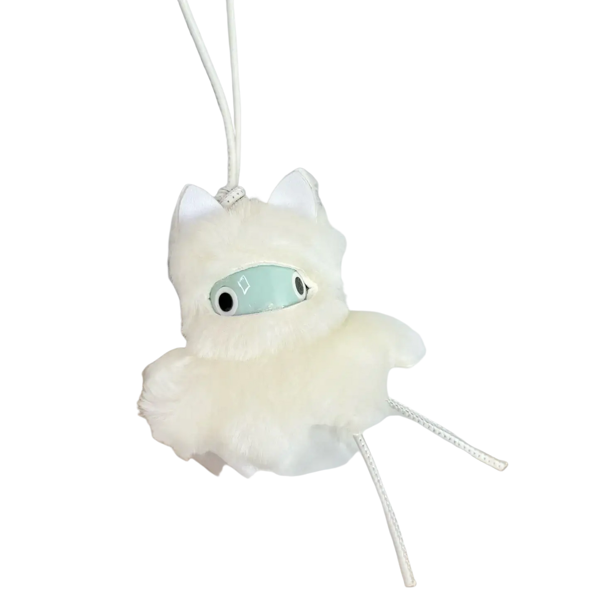 A fluffy white leather animal bag charm with mint green eyes silver metallic nose and soft fur texture on a white cord