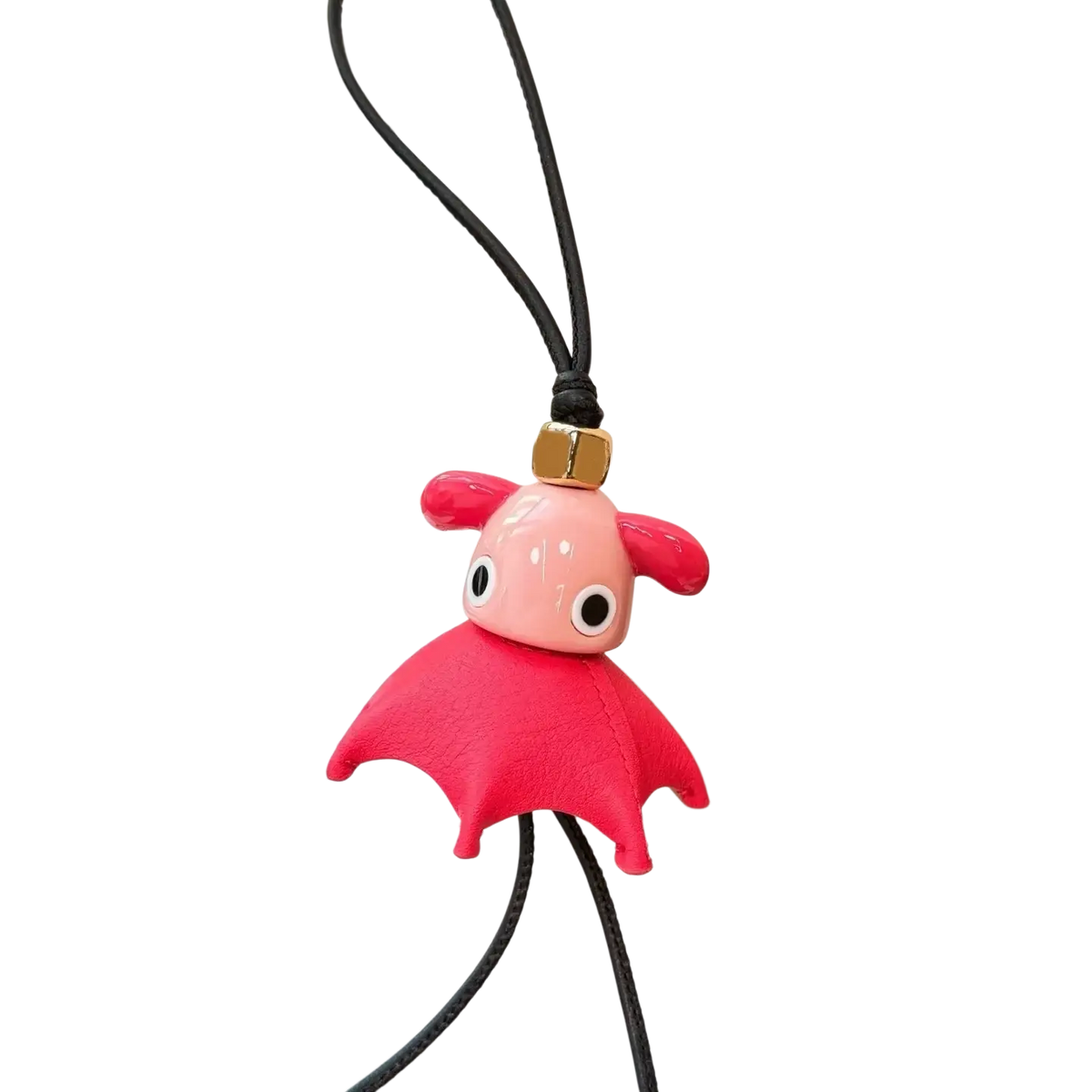 Leather animal bag charm featuring a pink bat with a glossy resin head and textured red leather wings on a black cord