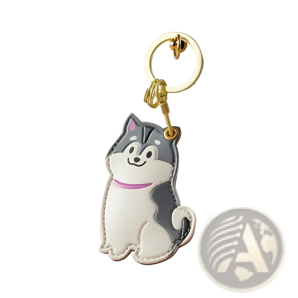 A white and gray husky-shaped leather keychain with pink collar attached to a gold metal ring for bag charm use