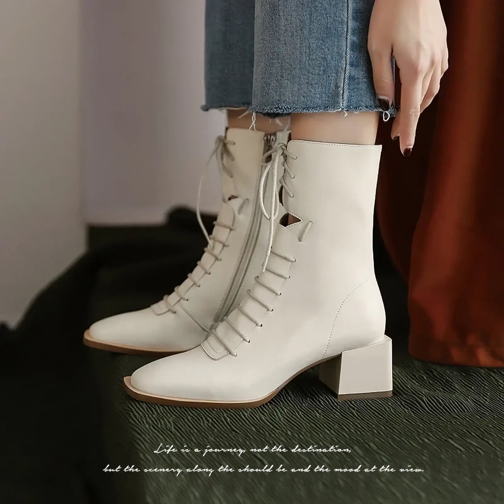 Cream-colored leather ankle boots with lace-up detailing and block heel ideal for winter wear