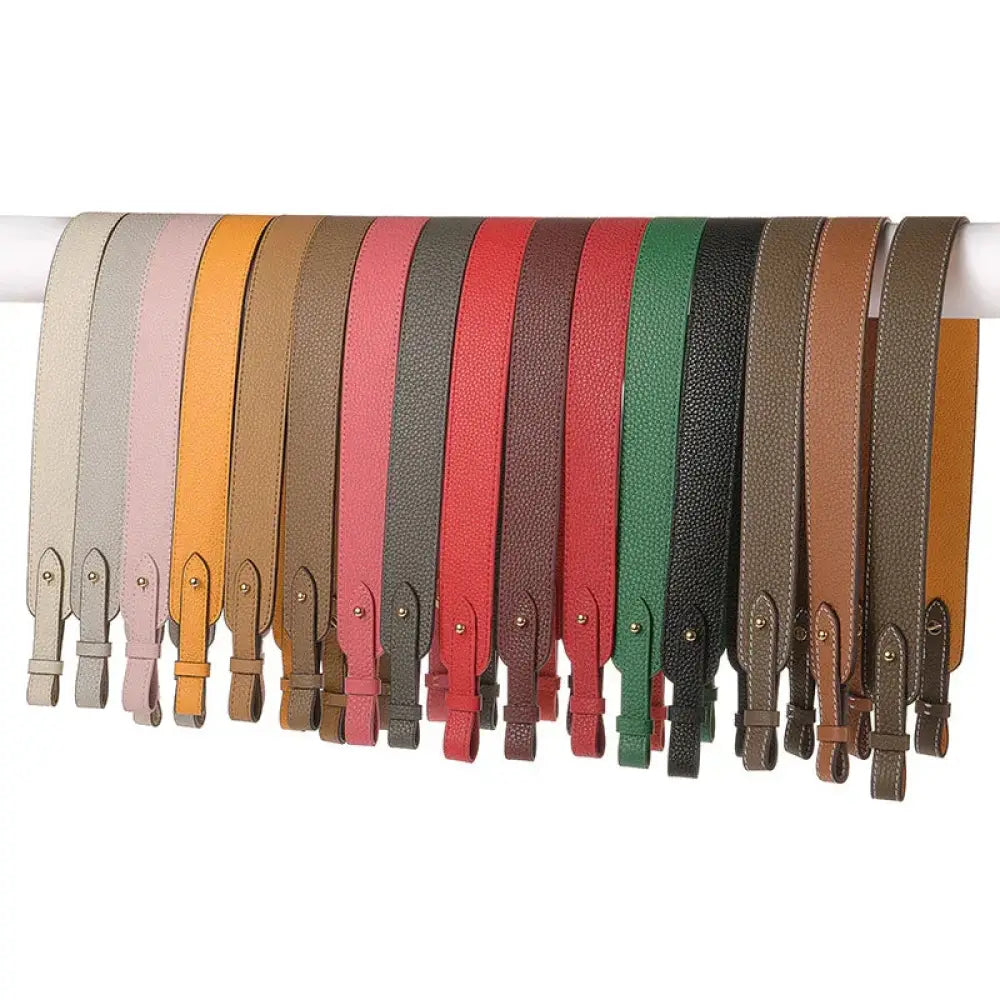 Adjustable textured leather handbag straps in various colors with matching gold clasps and textured surfaces