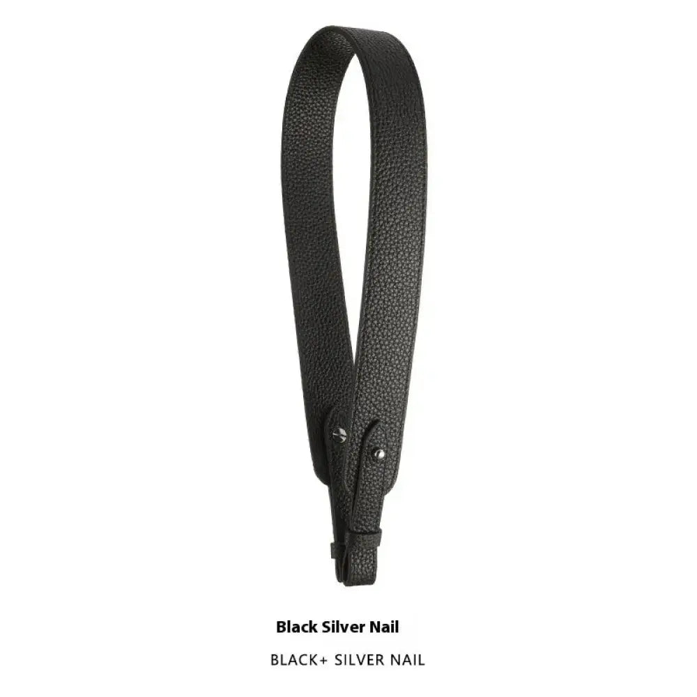 Adjustable black leather handbag strap with textured pebbled finish and silver nail-style hardware detailing
