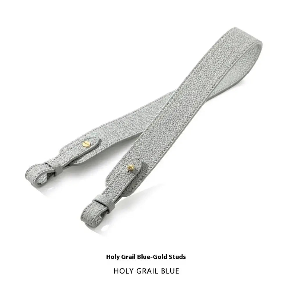 Adjustable textured light gray leather handbag strap with gold-tone studs and metal loops for secure attachment