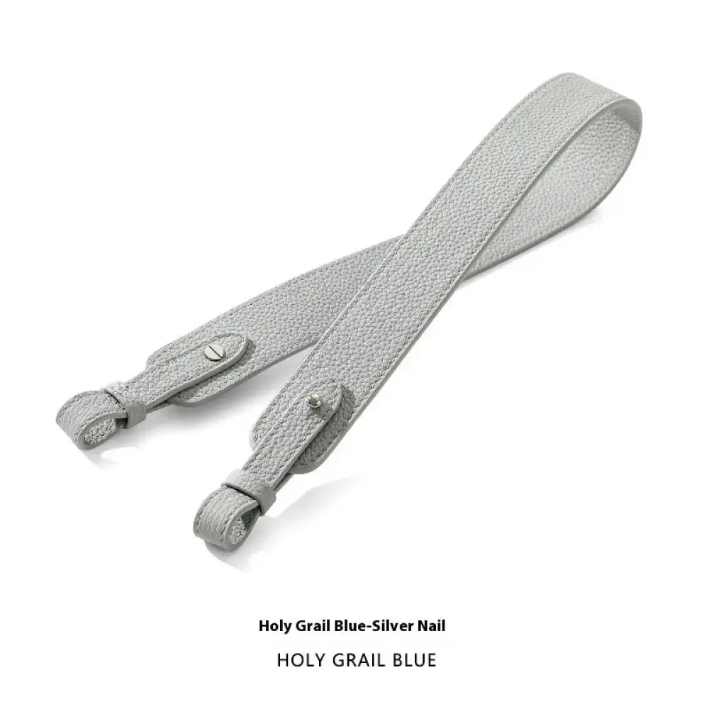Adjustable textured leather handbag strap in light gray with silver-toned metal hardware for versatile use