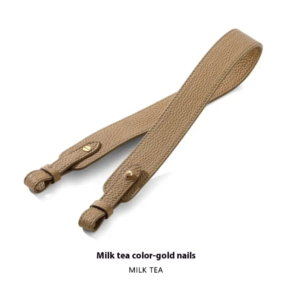 Adjustable textured leather handbag strap in milk tea with gold-tone hardware and pebbled leather finish
