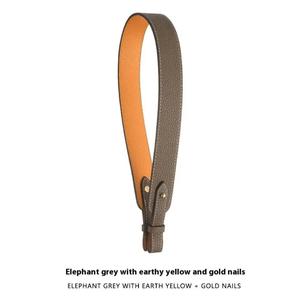 Adjustable textured leather handbag strap in elephant grey with earthy yellow lining and gold-toned hardware clasp