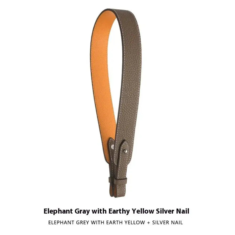 Adjustable textured leather handbag strap in elephant gray with earthy yellow lining and silver nail hardware
