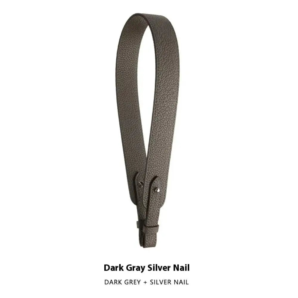 Adjustable textured leather handbag strap in dark gray with silver nail hardware and gold clasp for versatile use