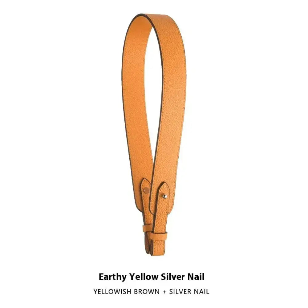 Adjustable earth-toned yellow textured leather handbag strap with silver nail hardware and gold clasp