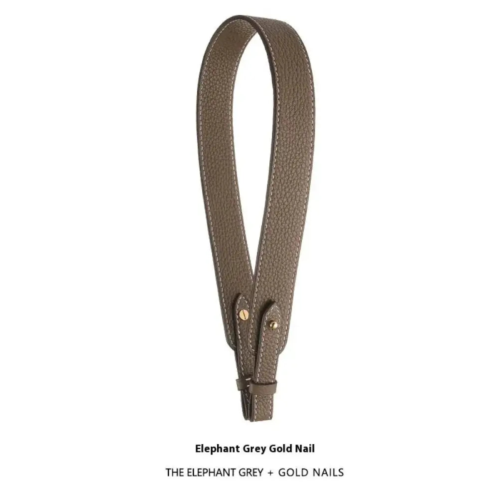 Adjustable textured leather handbag strap in elephant grey with gold-tone hardware accents