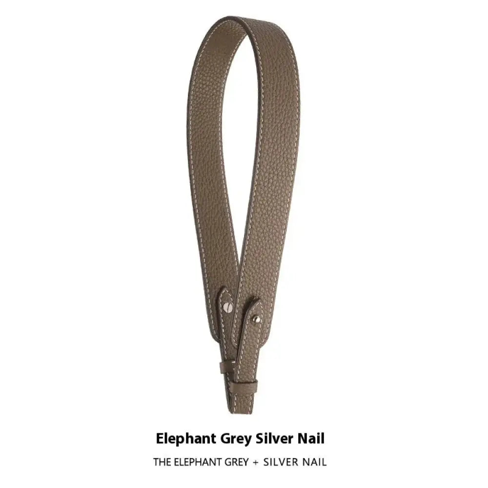 Adjustable textured leather handbag strap in elephant grey with silver nail hardware and gold clasp for versatile use
