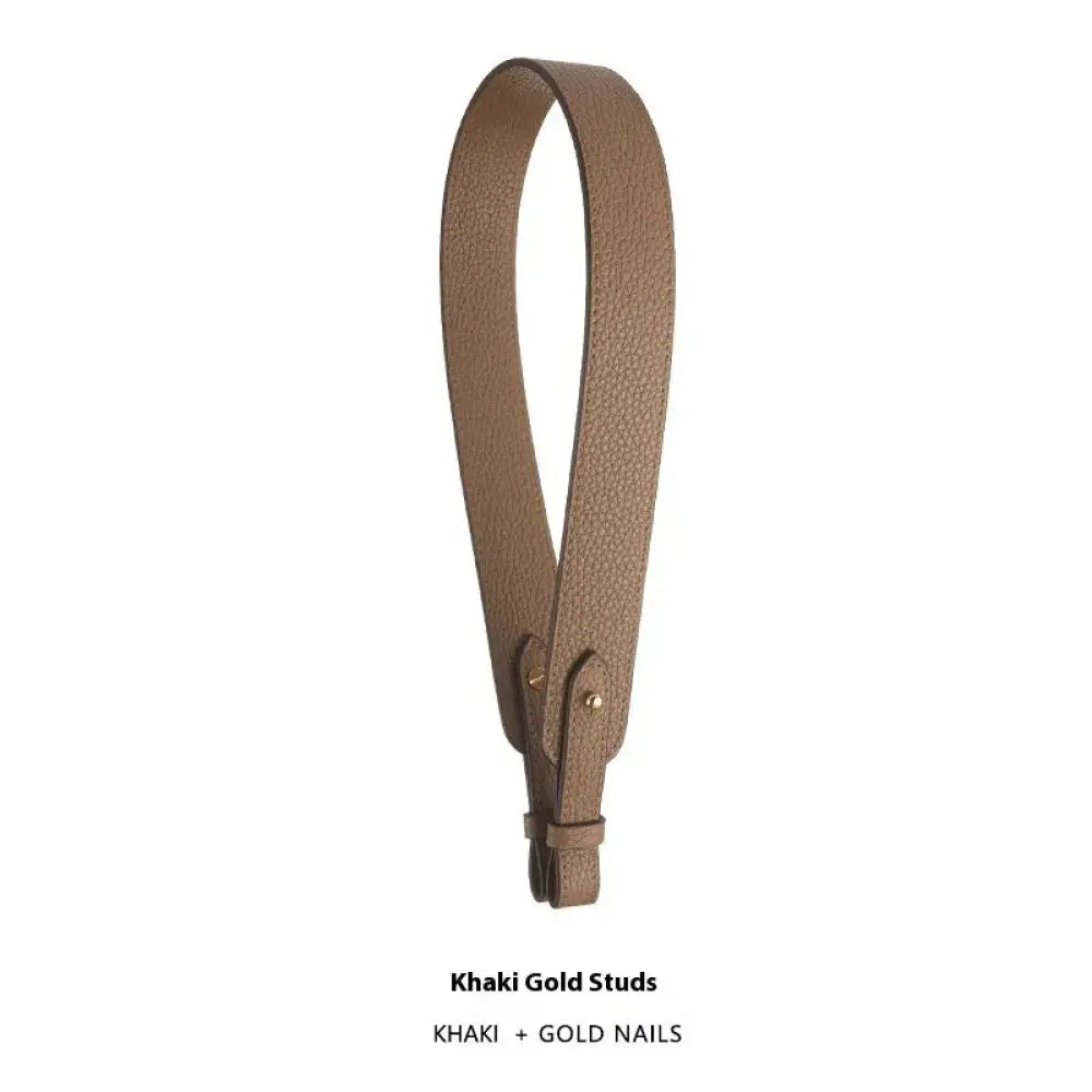 Khaki-colored adjustable textured leather handbag strap with gold-toned metal studs nails and gold clasp