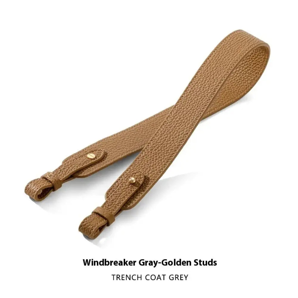 Adjustable grey leather handbag strap with textured surface gold clasp and golden studs for trench coat use