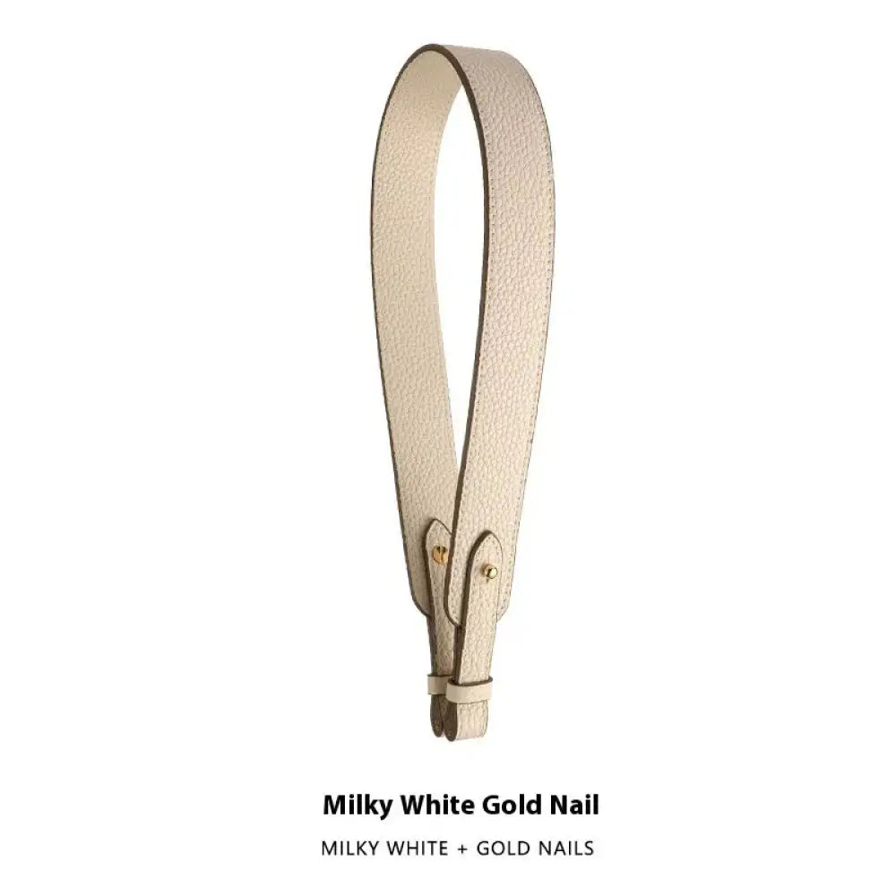 Adjustable textured leather handbag strap in milky white with gold-tone nail hardware and gold clasp