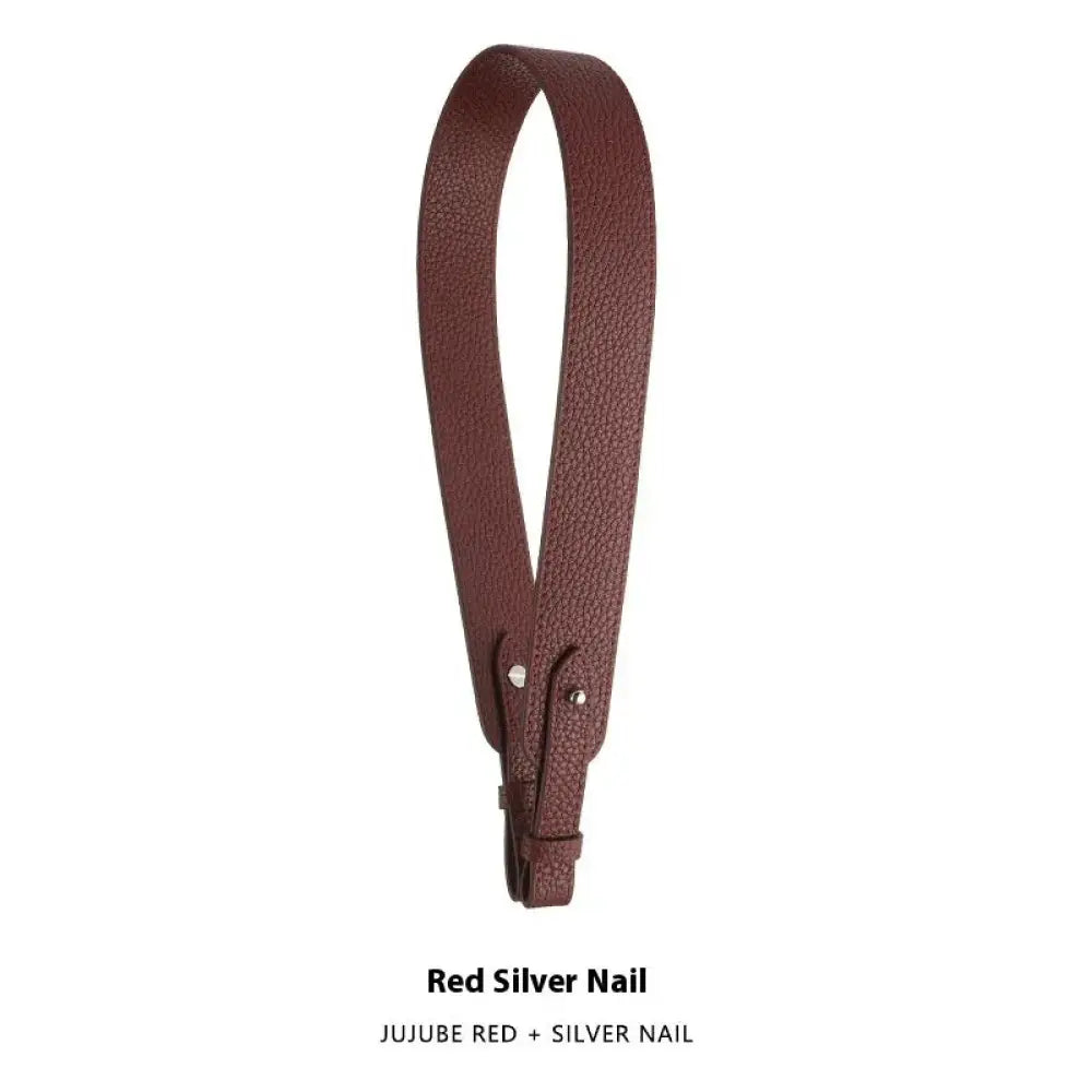 Adjustable textured leather handbag strap in brown with silver nail hardware and gold clasp for versatile use