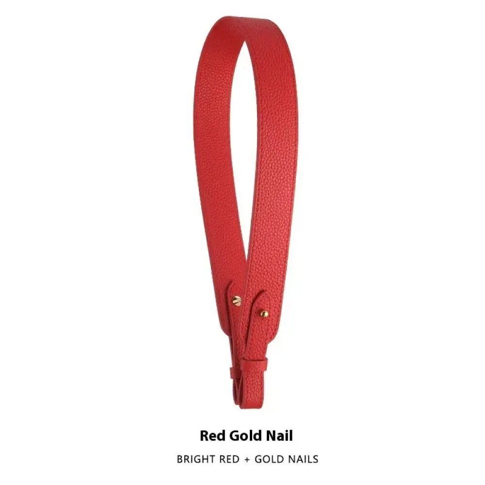 Adjustable textured leather handbag strap in bright red with gold-colored metal nails and gold clasp