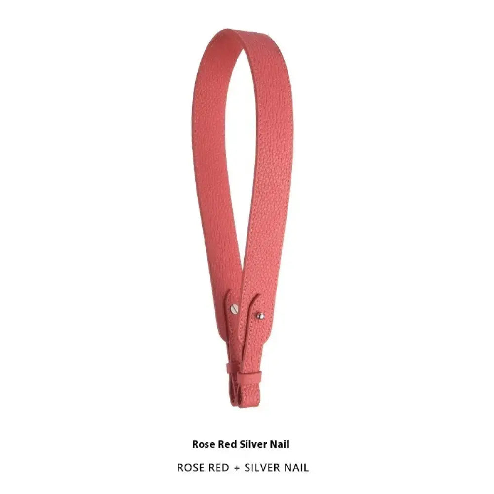 Adjustable rose red leather handbag strap with textured silver nail hardware and gold clasp for versatile use