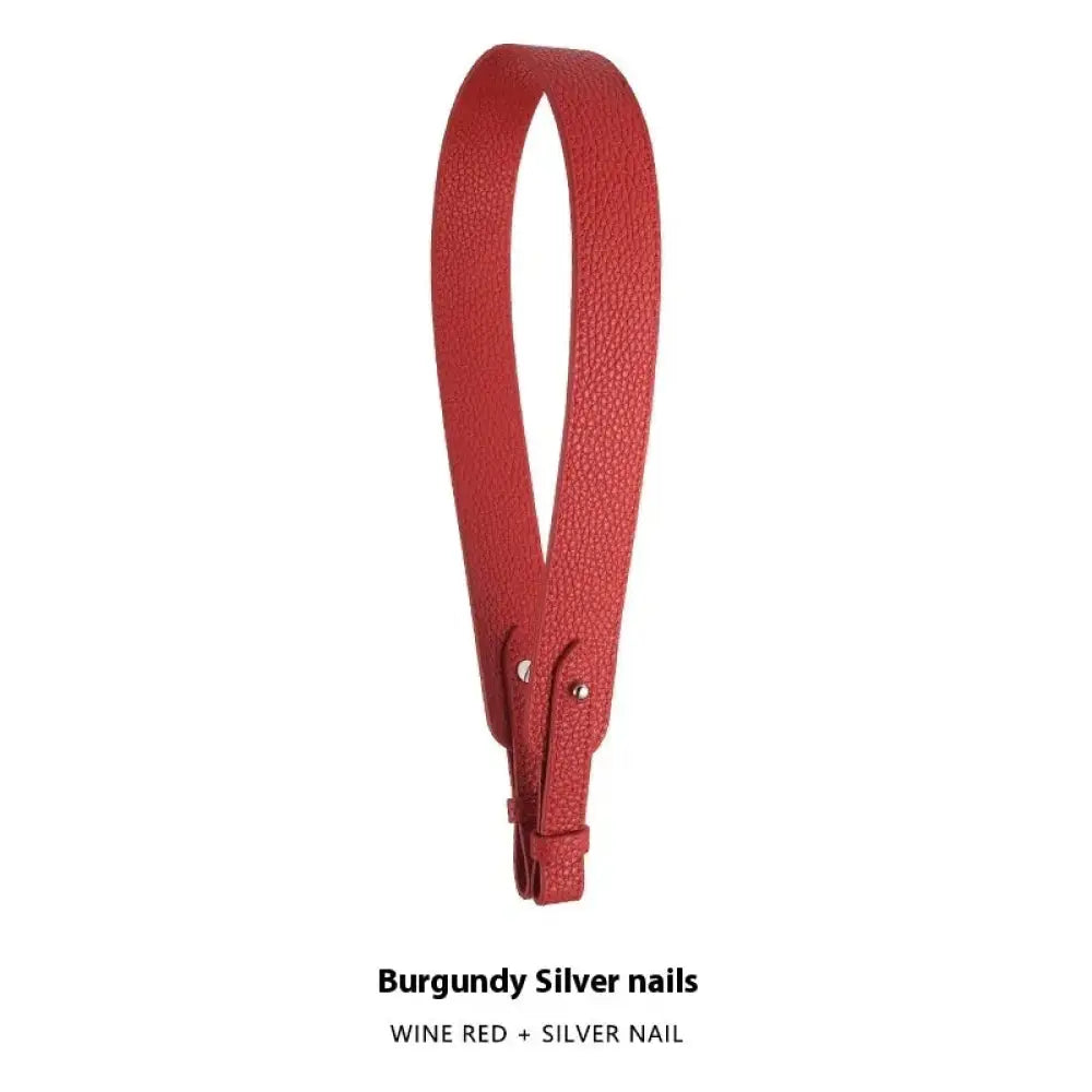 Adjustable textured leather handbag strap in burgundy with silver nail hardware and gold clasp detail