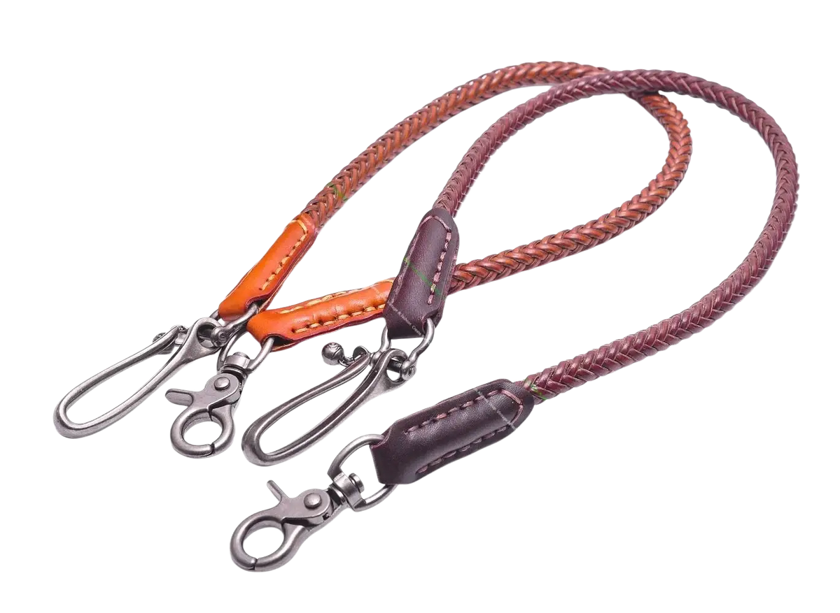 Two braided leather biker wallet chains in orange and dark brown with metal clasps and stitched ends for punk jeans