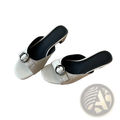Cream-colored leather square toe mule sandals for women with silver buckle detail and black insole