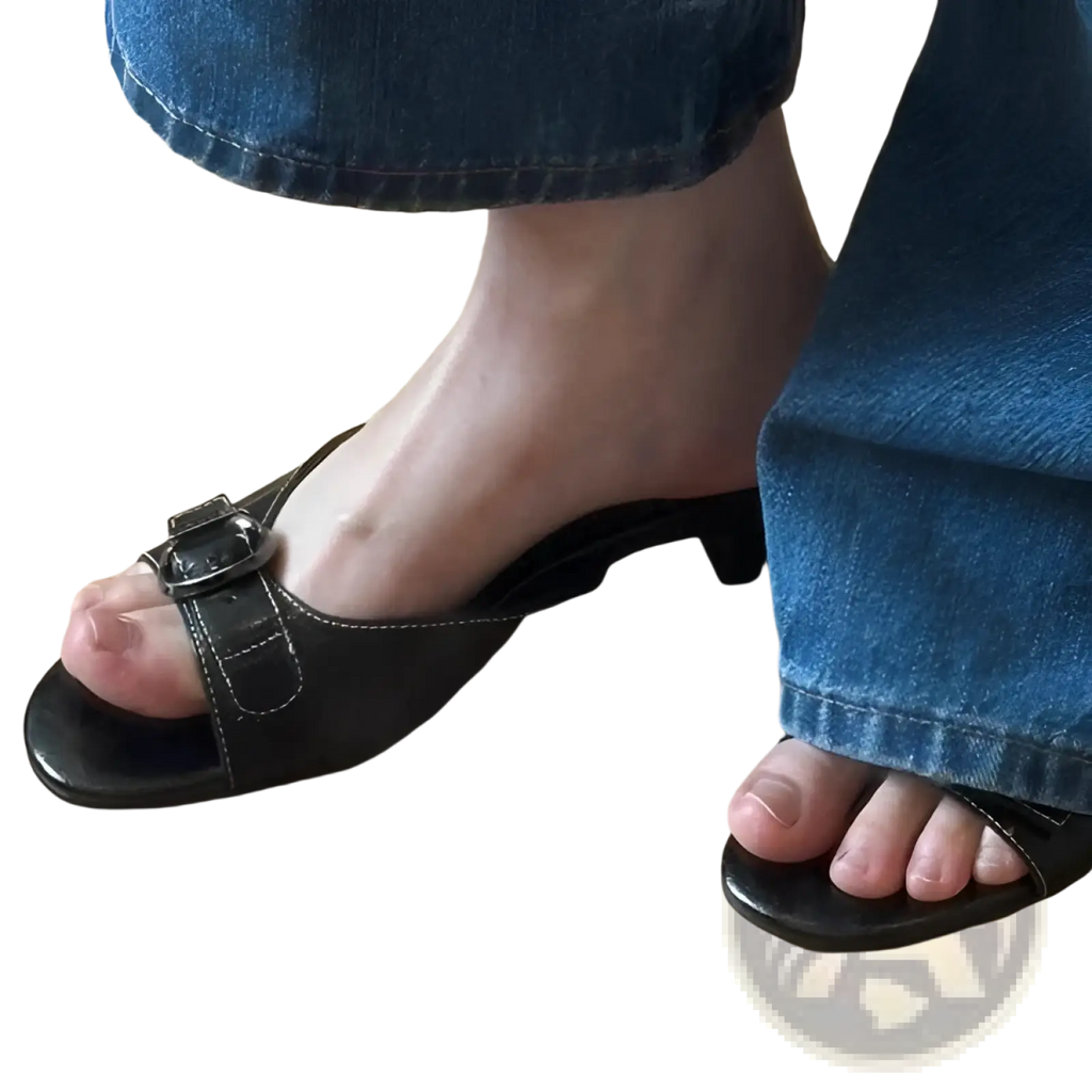 Black leather mule sandals for women with a square toe buckle strap and low heel shown from the back side