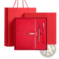 Red leather business notebook set with silver clasp and matching pen in a gift box for professional use