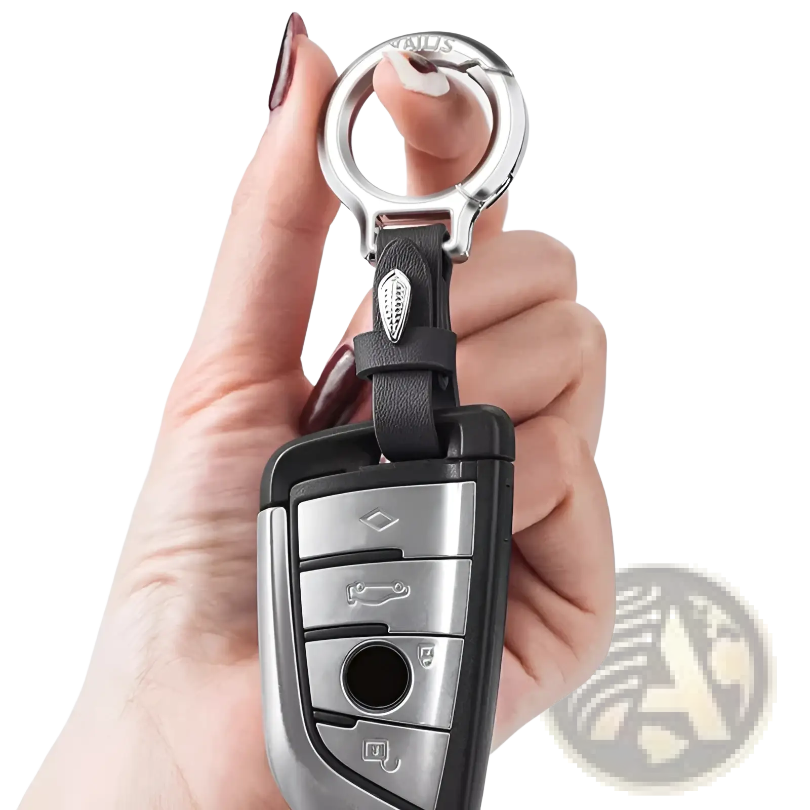 Black leather car keychain with silver metal ring and decorative leaf charm attached to a BMW key fob