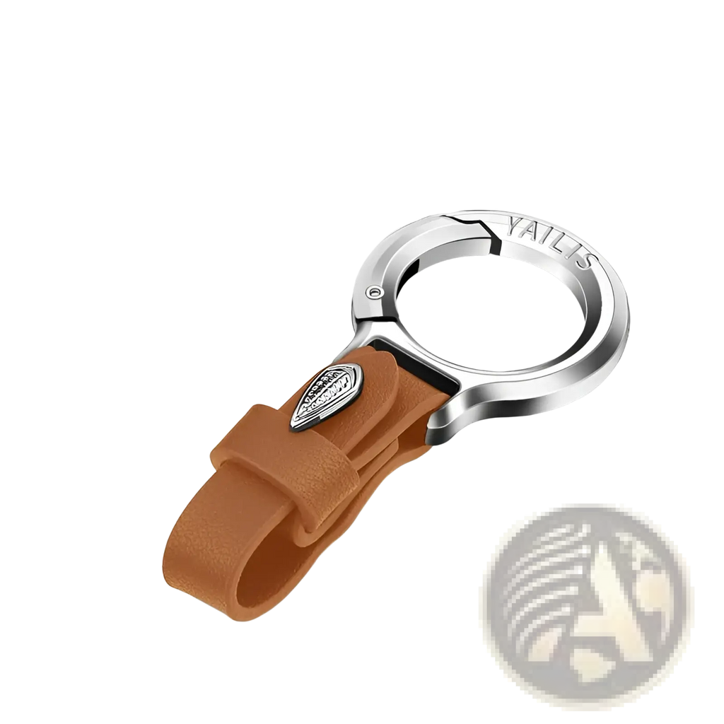 Leather car keychain in brown with a silver metal loop and a small engraved emblem on the leather ring