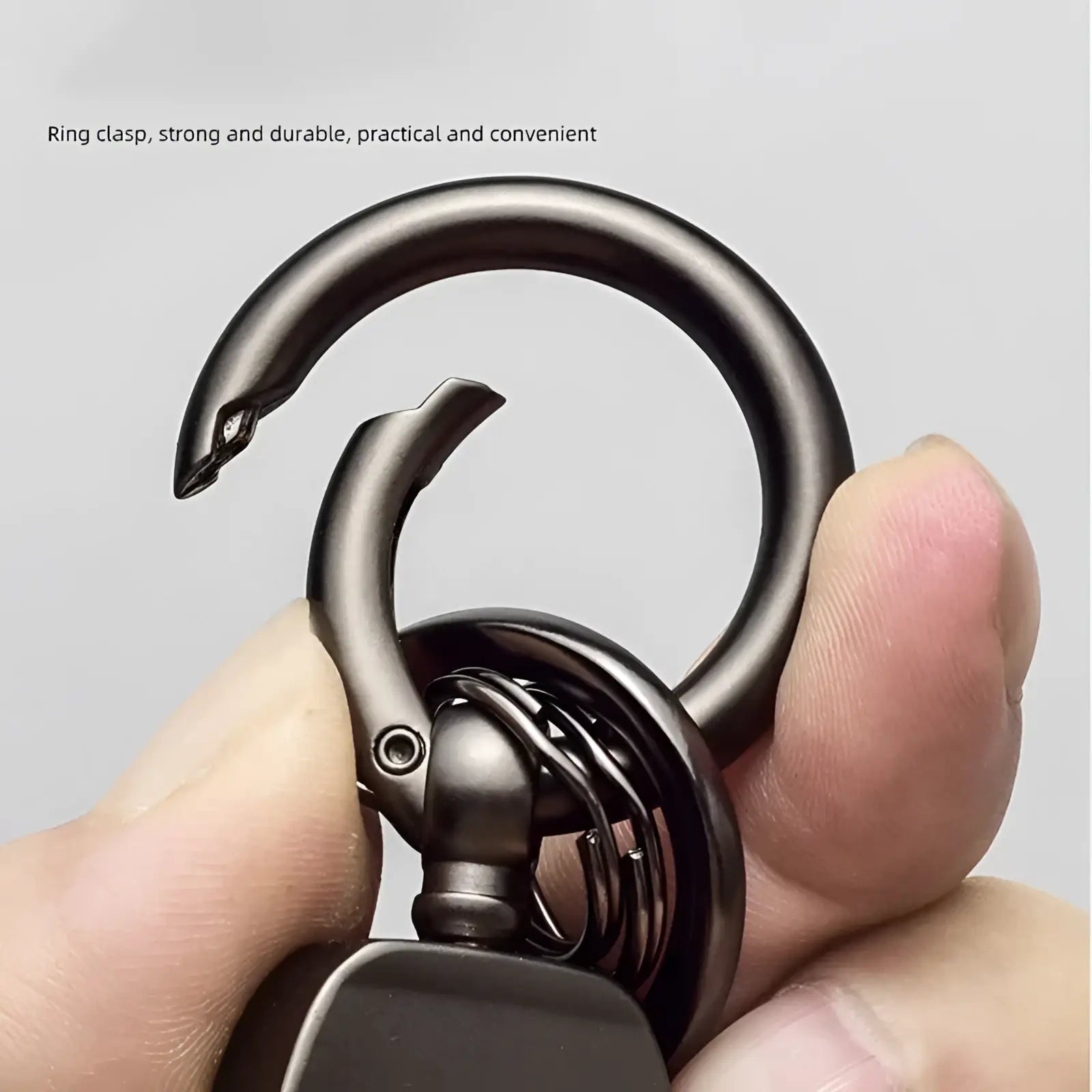 Dark metallic ring clasp with curved design and integrated lock on leather car keychain luxury genuine leather key ring