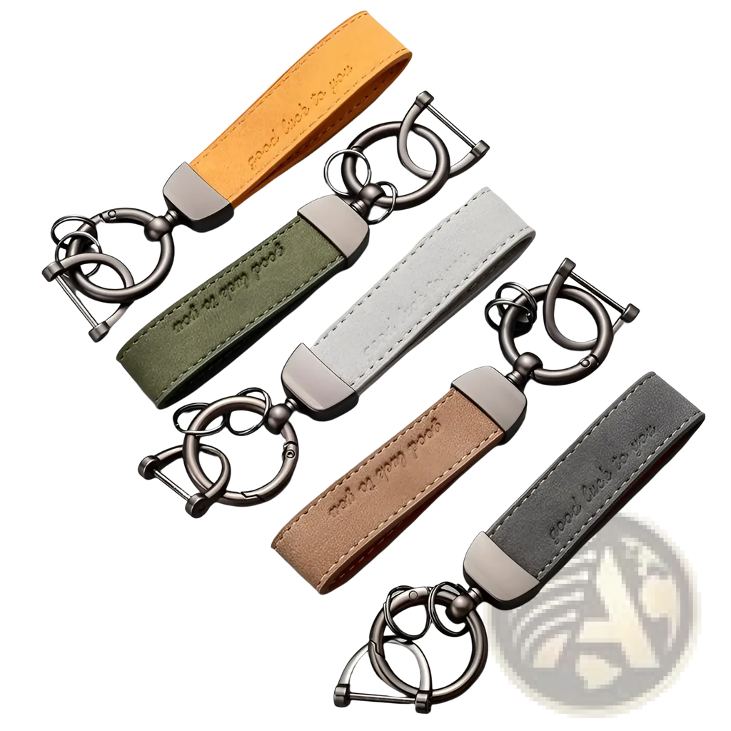 Set of four leather car keychains in orange, olive green, beige, and gray with brushed metal hardware
