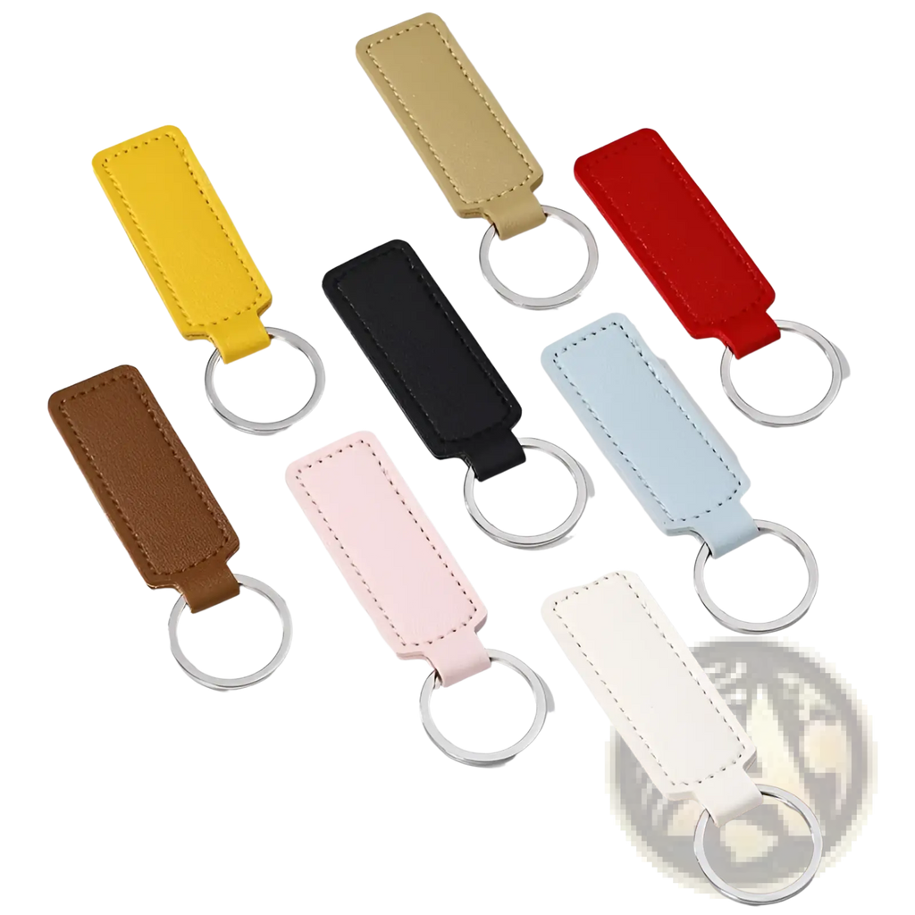 A collection of rectangular leather car keychain minimalist strip key rings in assorted colors including yellow and black