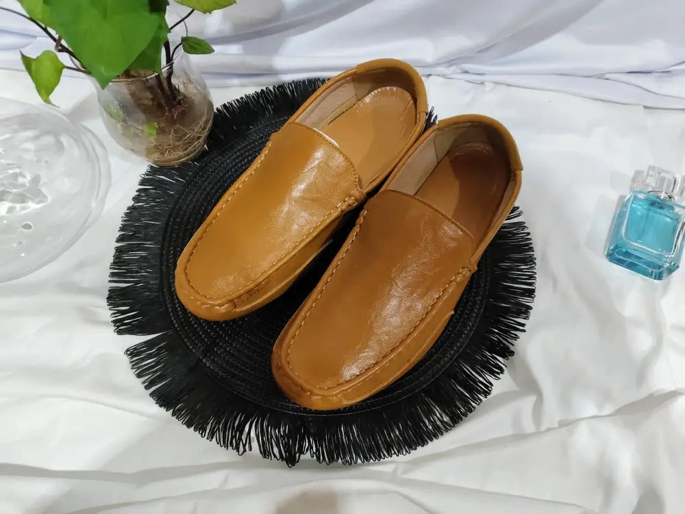 Men’s soft leather slip on loafers in tan with smooth glossy finish and classic moccasin-style stitching
