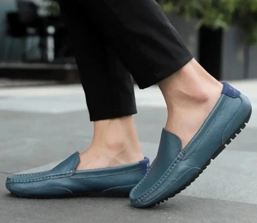Men’s soft leather slip on loafers in teal with navy blue accents and textured rubber sole for casual wear