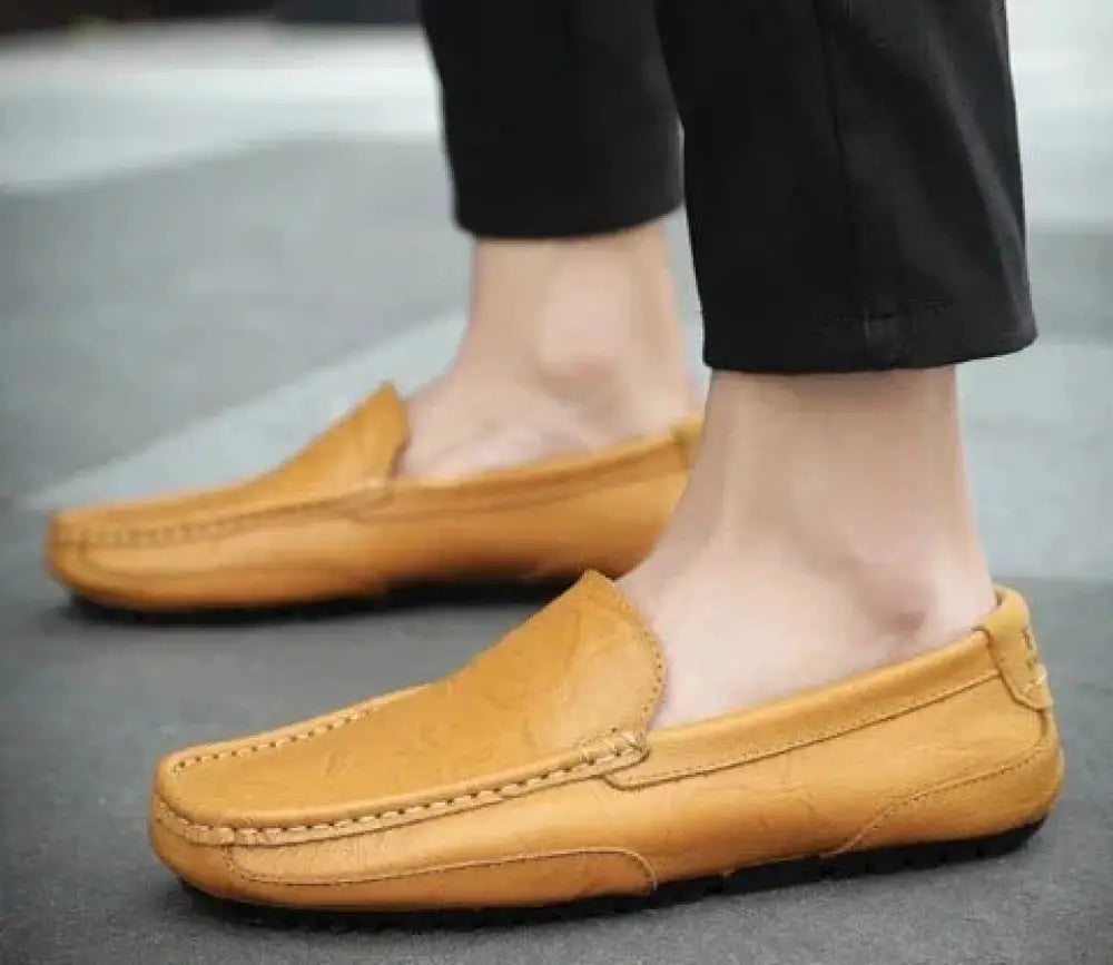 Men’s soft leather slip on loafers in tan with suede finish and visible stitching designed for casual wear