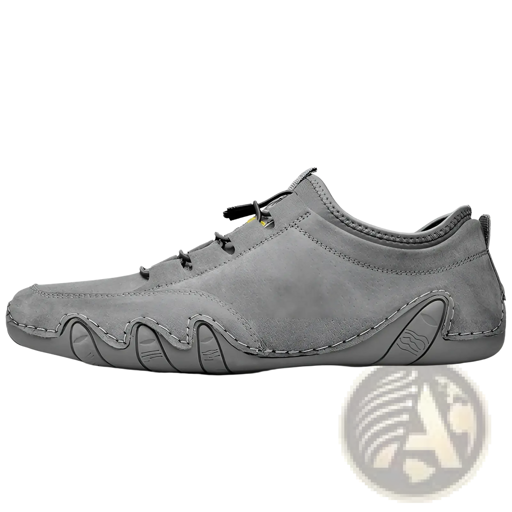 Gray suede leather casual slip on shoe with black laces and a textured wavy rubber sole for everyday wear