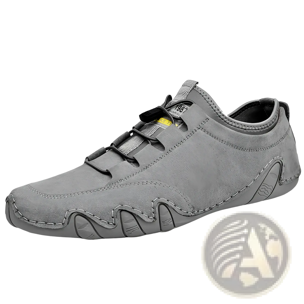 Gray leather casual shoes featuring suede slip-on design with black laces and distinctive wavy sole sneakers