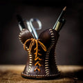 Handcrafted leather corset desk organizer and pen holder in brown with tan lacing and white stitching detailing