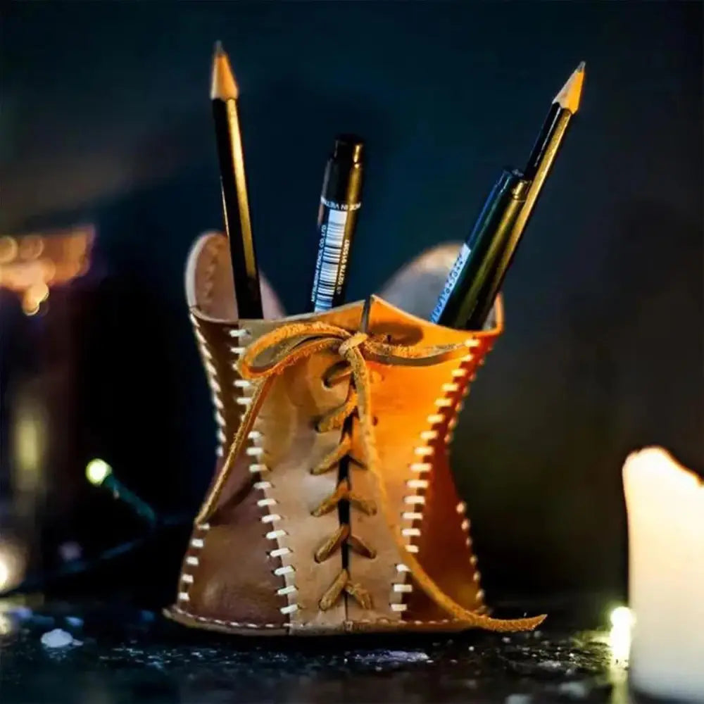 Handcrafted tan leather corset desk organizer and pen holder with white stitching and tied lace detail